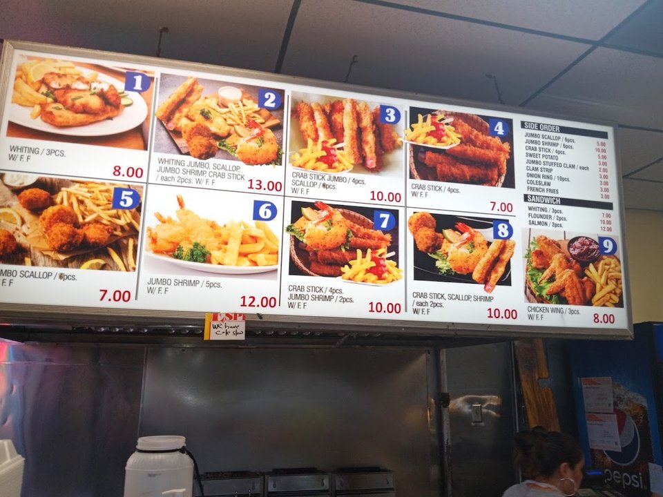 A seafood counter with fish and shellfish.