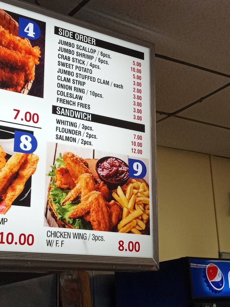 Menu board with crab and fish options.